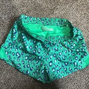 Green Athletic Shorts with Intricate Cut-Out Design